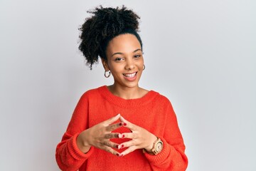 Young african american girl wearing casual clothes hands together and fingers crossed smiling relaxed and cheerful. success and optimistic