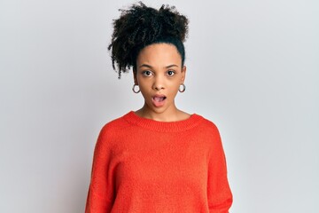 Young african american girl wearing casual clothes in shock face, looking skeptical and sarcastic, surprised with open mouth