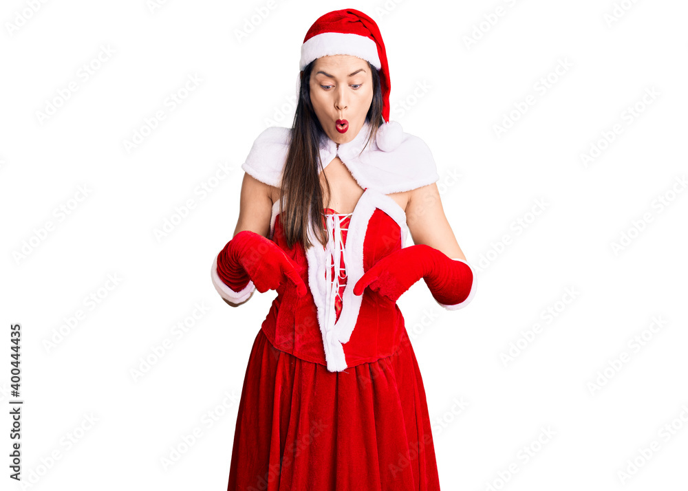 Poster young beautiful caucasian woman wearing santa claus costume pointing down with fingers showing adver