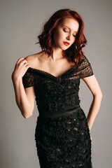 Black transparent long evening dress. Beautiful slim bending model wearing high heels, modern...