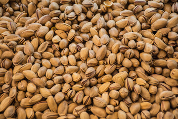 Pistachio texture. Nuts. Green fresh pistachios background. Top view. Roasted salted pistachio nuts healthy delicious food.