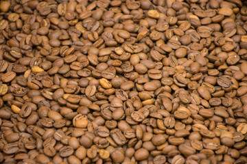 Dark many roasted coffee beans texture background. Top view