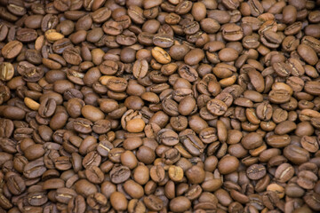 Dark many roasted coffee beans texture background. Top view