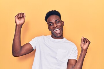 Young african american man wearing casual clothes dancing happy and cheerful, smiling moving casual...