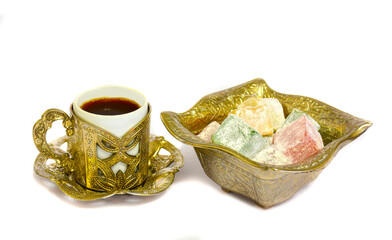 Traditional Turkish delight (blasting cartridge) in gold bowl with gold cup Turkish coffee. isolated on white background