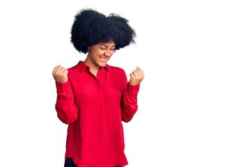 Young african american girl wearing casual clothes very happy and excited doing winner gesture with arms raised, smiling and screaming for success. celebration concept.