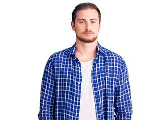 Obraz premium Young handsome caucasian man wearing casual clothes depressed and worry for distress, crying angry and afraid. sad expression.