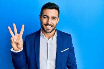 Young hispanic businessman wearing business jacket showing and pointing up with fingers number...