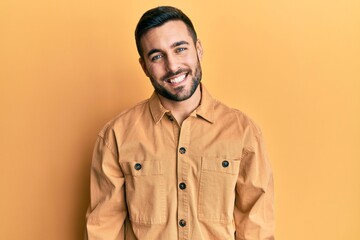 Young hispanic man wearing casual clothes with a happy and cool smile on face. lucky person.