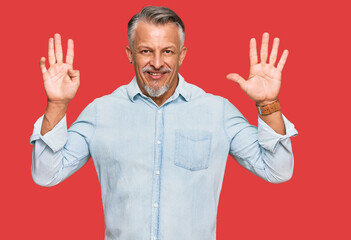 Middle age grey-haired man wearing casual clothes showing and pointing up with fingers number nine...