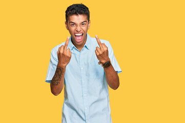 Young handsome african american man wearing casual clothes showing middle finger doing fuck you bad...
