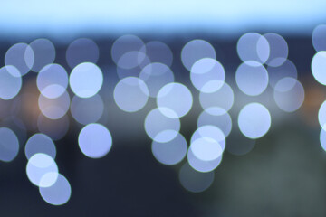 Blurred white lights on blue-gray background