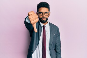 Handsome hispanic business man with beard wearing business suit and tie looking unhappy and angry...