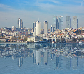 Panoramic view of Istanbul European side from the Asian side. Skyscrapers, hotels and modern offices near old historical tradition buildings. Bosporus on the front of image.