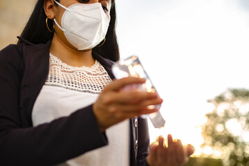 Close-up of a Latin businesswoman wearing a face mask for protective reasons during the covid 19...