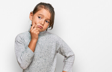 Little beautiful girl wearing casual turtleneck sweater serious face thinking about question with hand on chin, thoughtful about confusing idea