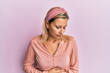 Middle age caucasian woman wearing casual clothes with hand on stomach because indigestion, painful...