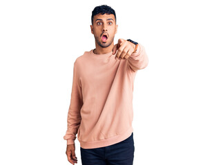 Young hispanic man wearing casual clothes pointing displeased and frustrated to the camera, angry...
