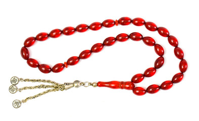 Red amber prayer beads (rosary) on white background.