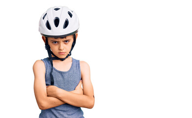 Little cute boy kid wearing bike helmet skeptic and nervous, disapproving expression on face with crossed arms. negative person.