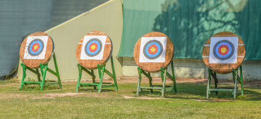 outdoor archery targets on grass field in summer day