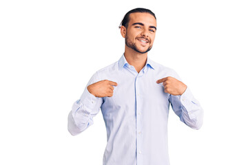 Young handsome man wearing business clothes looking confident with smile on face, pointing oneself...