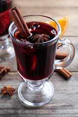 Delicious red mulled wine on wooden table, closeup