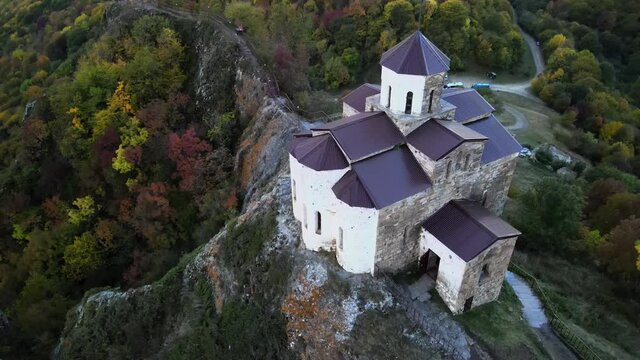 Christian active Shoanin temple. X century. Karachay-Cherkessia, Teberda, Russia. Mountain open. Drone shooting