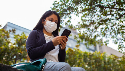 Latin businesswoman wearing a face mask for protective reasons during the covid 19 pandemic.