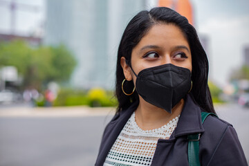 Latin businesswoman wearing a face mask for protective reasons during the covid 19 pandemic.