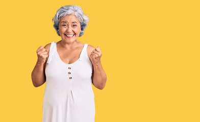 Senior woman with gray hair wearing casual clothes excited for success with arms raised and eyes closed celebrating victory smiling. winner concept.