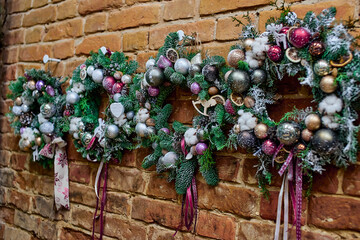 decorated Christmas wreaths with lots of ornaments balls and Christmas tree toys