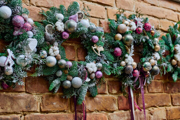 decorated Christmas wreaths with lots of ornaments balls and Christmas tree toys