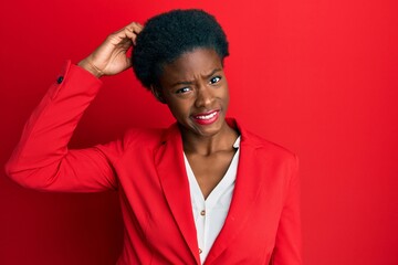 Young african american girl wearing business clothes confuse and wonder about question. uncertain with doubt, thinking with hand on head. pensive concept.