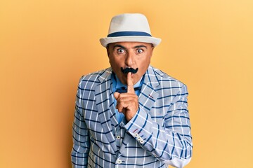 Mature middle east man with mustache wearing vintage and elegant fashion style asking to be quiet...