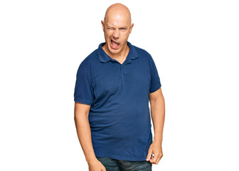 Fototapeta premium Middle age bald man wearing casual clothes winking looking at the camera with sexy expression, cheerful and happy face.