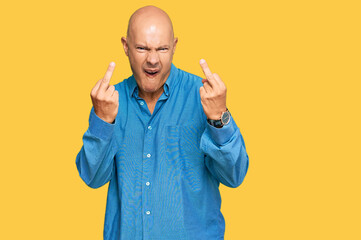 Middle age bald man wearing casual clothes showing middle finger doing fuck you bad expression,...
