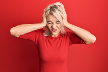 Young blonde girl wearing casual clothes suffering from headache desperate and stressed because...