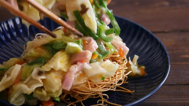 長崎皿うどんの動画。揚げた麺に野菜たっぷりの餡かけをかけて食べる料理。