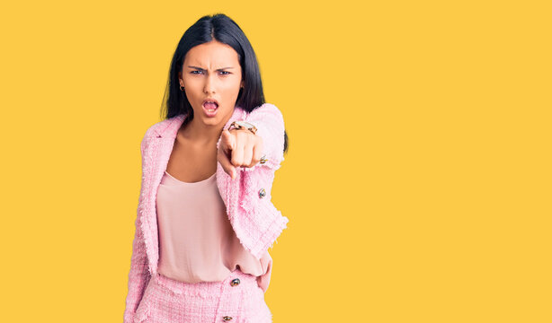 Young beautiful latin girl wearing business clothes pointing displeased and frustrated to the camera, angry and furious with you