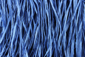 Background - blue paper raffia strips situated in parallel lines.