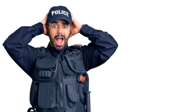 Young hispanic man wearing police uniform crazy and scared with hands on head, afraid and surprised of shock with open mouth