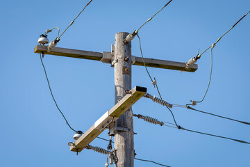 Wood Utility Pole with Lines against a Blue Sky