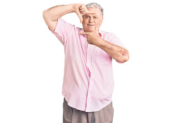 Senior grey-haired man wearing casual clothes smiling making frame with hands and fingers with happy face. creativity and photography concept.