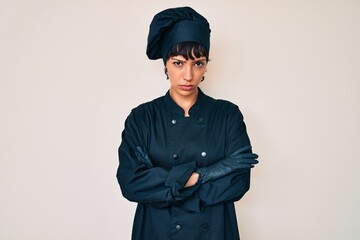 Beautiful brunettte woman wearing professional cook uniform skeptic and nervous, disapproving expression on face with crossed arms. negative person.