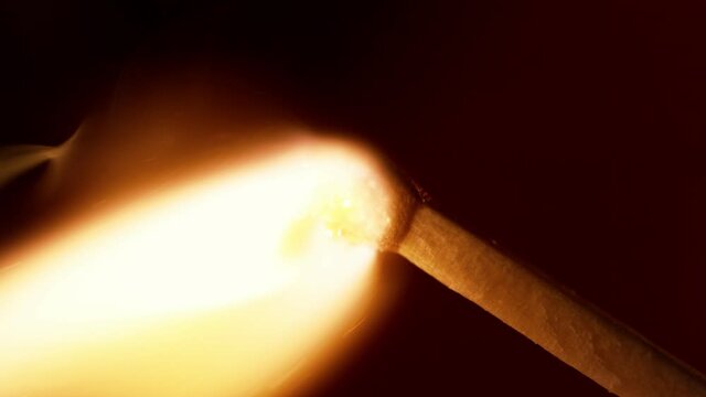 Super slow motion of striking a match, macro view,  dark background. Filmed on high speed cinema camera, 1000fps.