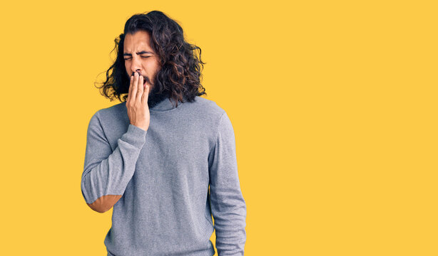 Young arab man wearing casual clothes bored yawning tired covering mouth with hand. restless and sleepiness.
