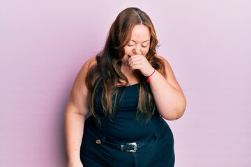 Plus size caucasian young woman wearing casual clothes over pink background feeling unwell and coughing as symptom for cold or bronchitis. health care concept.