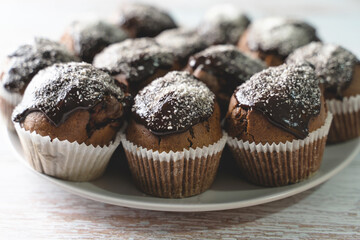 Close up on chocolate muffin cakes in a plate on table