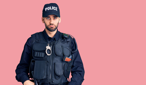 Young handsome man with beard wearing police uniform depressed and worry for distress, crying angry and afraid. sad expression.